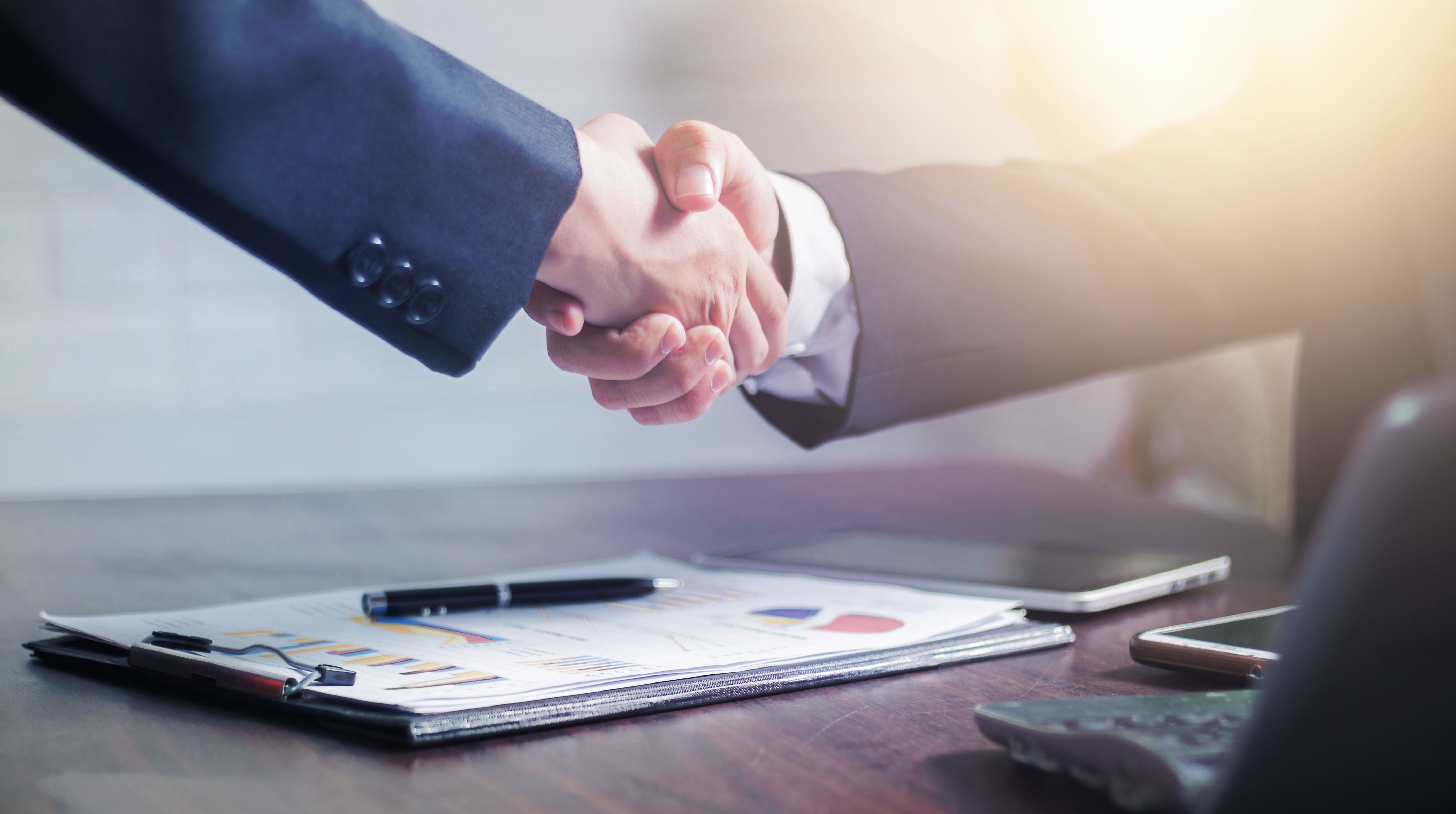 Handshake between an XcelMag consultant and a client